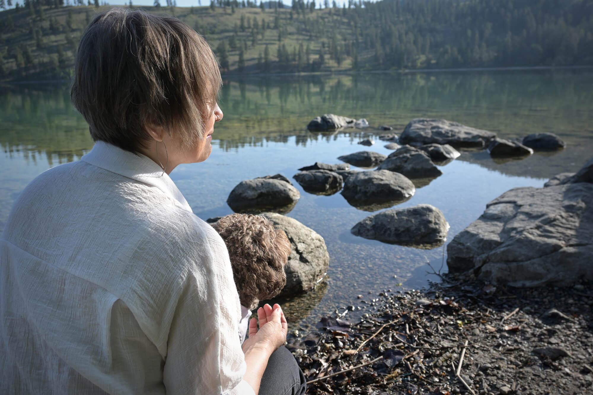 Lois of Lake Country Psychotherapy Counselling looking out into the water in Lake Country, BC